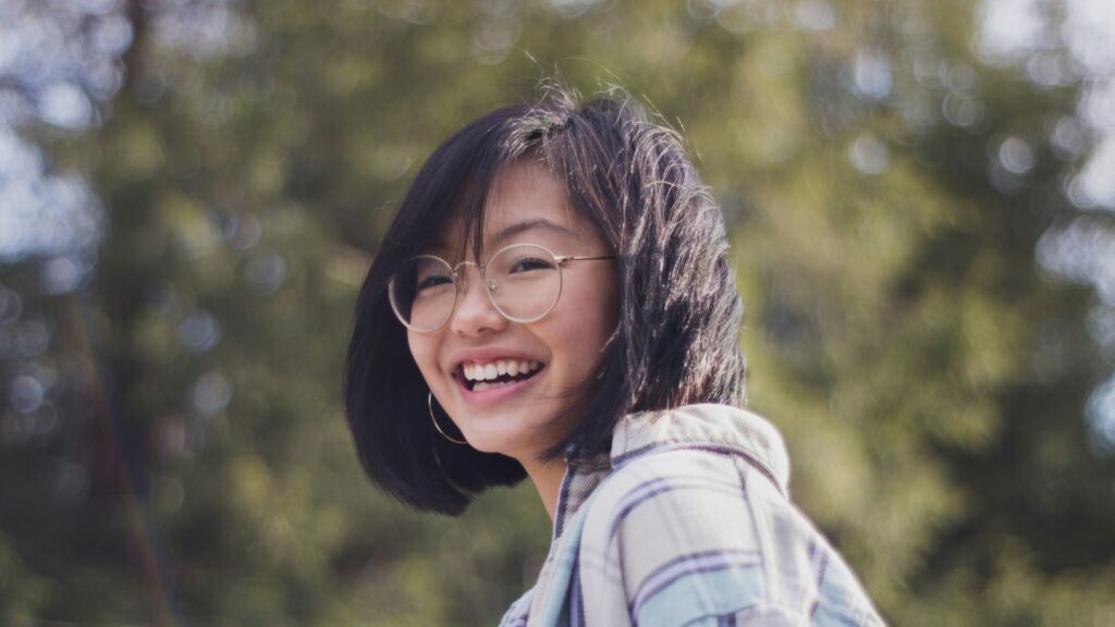 Woman smiling against blurred background