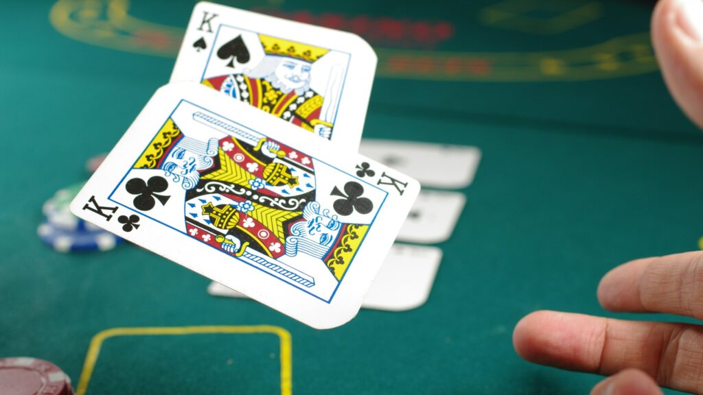 Player throwing King cards